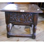 An antique oak locker joint stool with carved frieze and turned supports