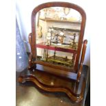 A Victorian mahogany framed platform dressing table mirror with scroll supports and serpentine base,