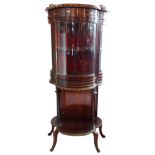 A French empire period style gilt metal mounted walnut vitrine with cast gallery, three curved glass