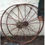 Two large vintage iron agricultural machine wheels, one by Bamfords of Uttoxeter (JCB)