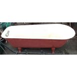 A 5' 4" Victorian cast iron bath set on cabriole legs, with tap