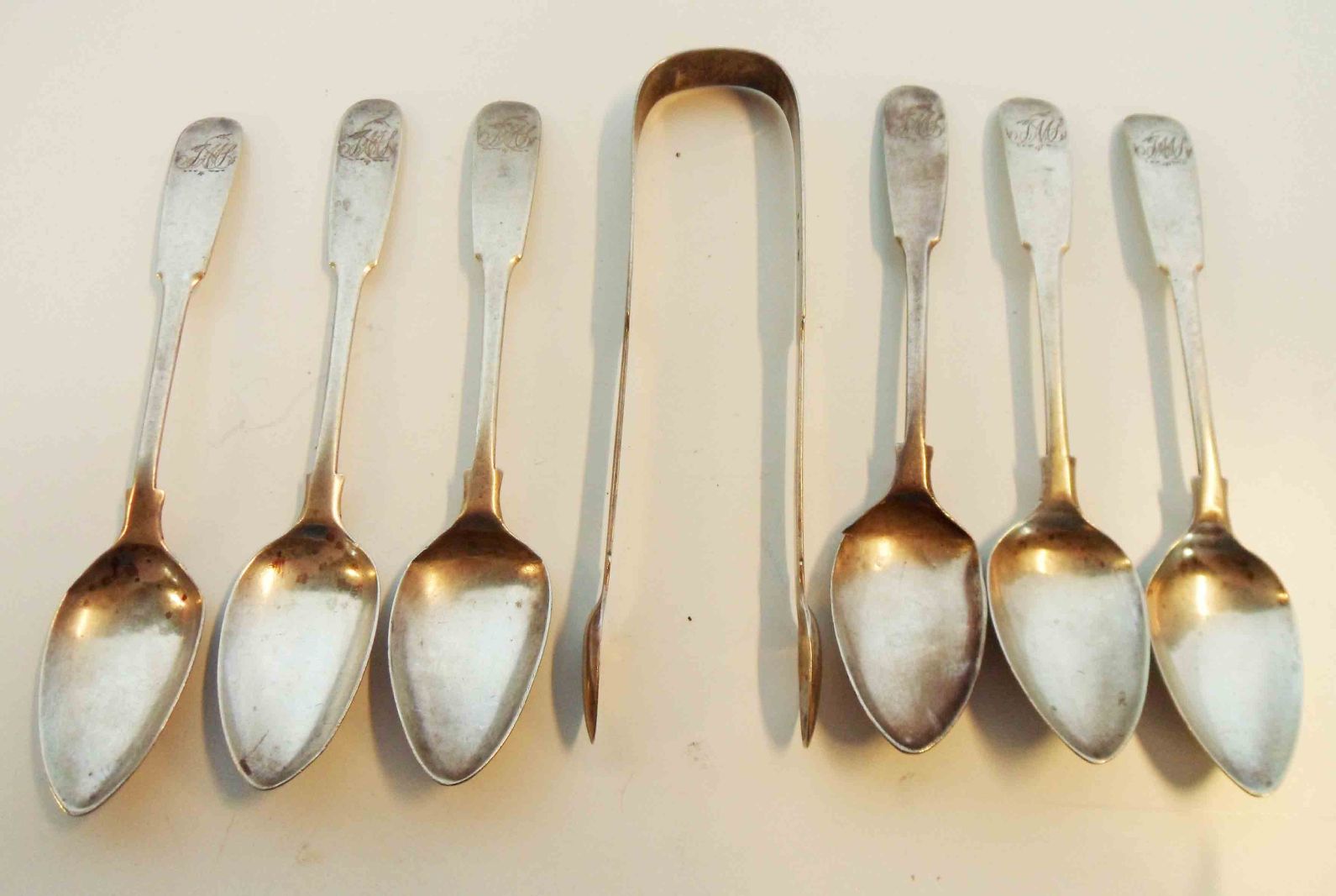 A set of six Georgian silver fiddle pattern teaspoons - a/f - sold with a pair of Georgian Newcastle