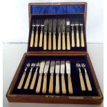 A Spink & Sons oak cased part set of silver fish knives and forks (twelve each, one fork