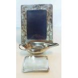 An Art Nouveau silver fronted photograph frame - sold with a silver sauce boat - Birmingham 1905 and
