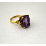 AN AMETHYST RING, with large rectangular shape amethyst to the fancy tapered shank, stamped 9ct,