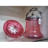 A CRANBERRY COLOURED BISCUIT BARREL, with plated mounts, together with cranberry coloured glass dish