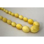 A STRAND OF IVORY BEADS, largest beads measuring 15mm x 22mm, length 50cm