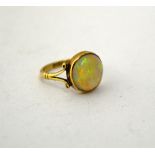 AN OPAL RING, with circular shape opal to the two pronged tapered band, stamped 9ct, ring size N1/2