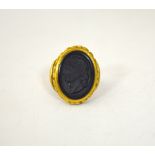 A CAMEO RING, depicting a Roman man in profile to the fancy tapered surround, ring size Q