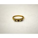 A 9CT GOLD RED STONE AND CUBIC ZIRCONIA RING, with fancy scrolling tapered sides, ring size P