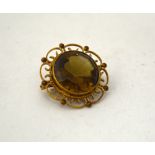 A CITRINE BROOCH, with circular scalloped fancy surround