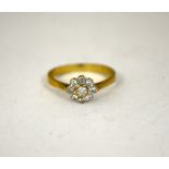 A DIAMOND CLUSTER RING, with brilliant cut diamonds in a daisy shape, estimated total diamond weight