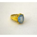 A DIAMOND AND TOPAZ DRESS RING, with central oval shape topaz to the tapered diamond shank,