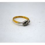 AN 18CT GOLD DIAMOND RING, with three single cut diamonds on a twisted shank, stamped 18ct and PLAT