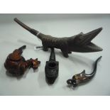 FOUR FIGURAL PIPES, a treen crocodile, approx 25cm long, open mouthed crocodile head, approx 14cm,