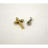 TWO DIAMOND PENDANTS, to include a small diamond cross and a tear drop shape pendant