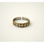 AN 18CT GOLD DIAMOND BAND RING, with nine brilliant cut diamonds to the plain tapered band,