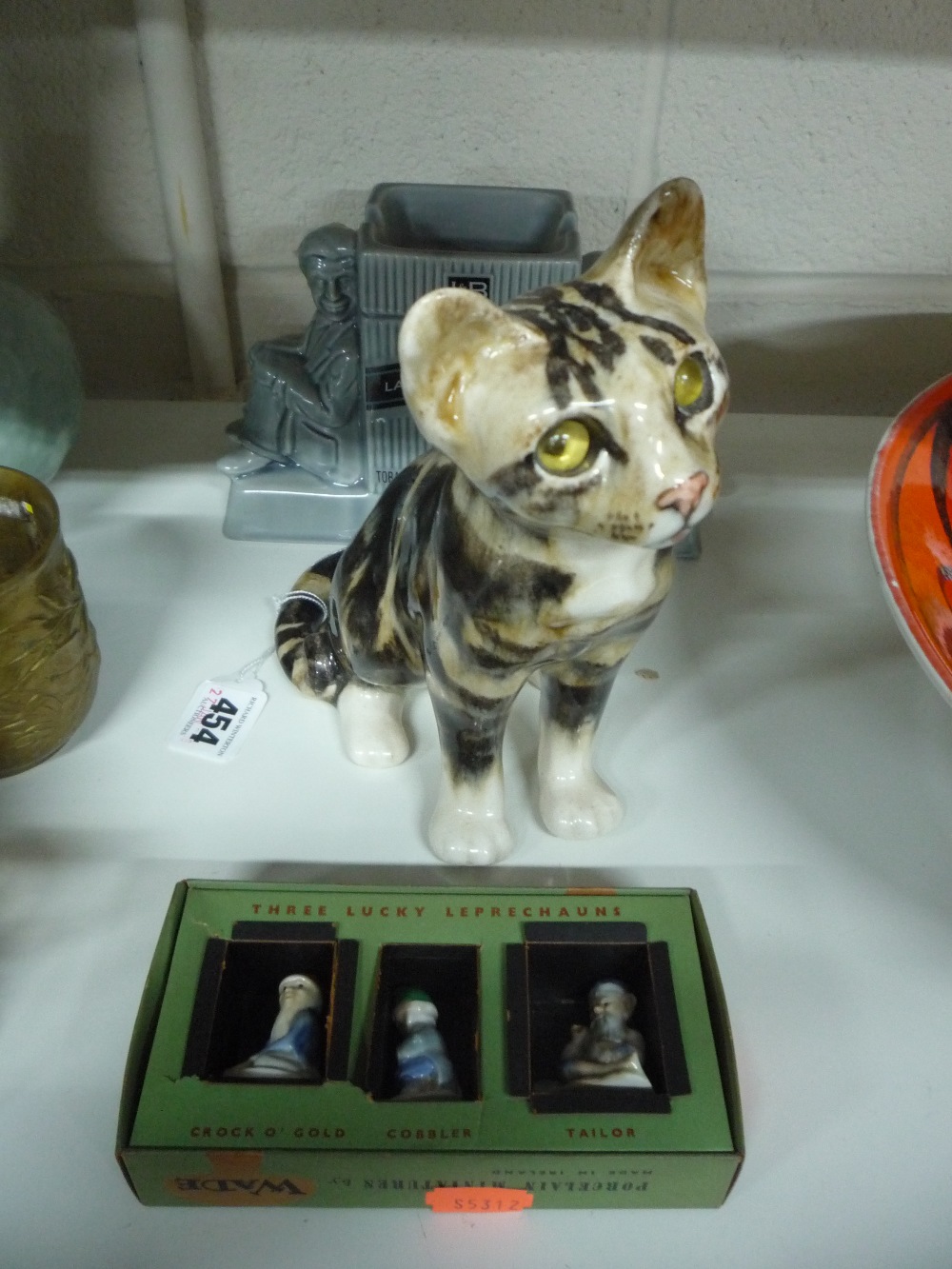 A WINSTANLEY SEATED KITTEN, height approximately 20cm, together with boxed Wade 'Three Lucky