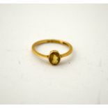 A 9CT GOLD CITRINE RING, with oval shape citrine to the plain band, hallmarks for Chester, ring size