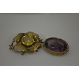 TWO EARLY 20TH CENTURY BROOCHES, the first an amethyst and seed pearl brooch together with a citrine