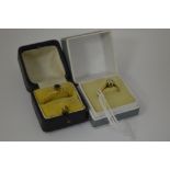 TWO 9CT GOLD RINGS, the first a brilliant cut diamond ring, M 1/2, together with another, N,