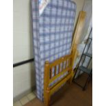 A PINE SINGLE BED WITH MATTRESS