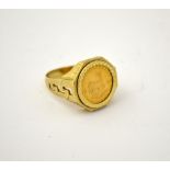 AN 18CT GOLD RING, with 1/10 Krugerrand, to a hexagonal shape surround and a Greek key design,