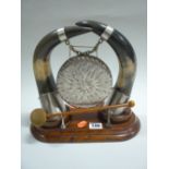 AN OAK AND PLATED DINNER GONG, mounted with horn supports, height approximately 26cm x length 29cm