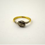 A DIAMOND RING, with three old cut diamonds to the twisted shank, stamped 18ct and Plat, ring size