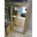 A LARGE MODERN WALL MIRROR, with light oak frame