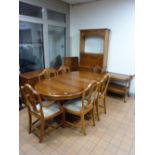 A YEW WOOD DINING SUITE, comprising extending dining table (one extra leaf), six chairs including