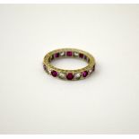 AN EARLY 20TH CENTURY RING, designed as ruby coloured paste and claer paste stones to engraved