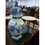 A LARGE ORIENTAL STYLE BLUE AND WHITE VASE, with cover (s.d.), occasional table with needlework top,