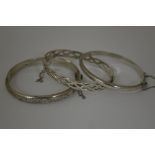 THREE BANGLES, one with Celtic knotted design, together with two other bangles, hallmarks for