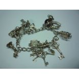 A SILVER CHARM BRACELET, (including twelve charms)