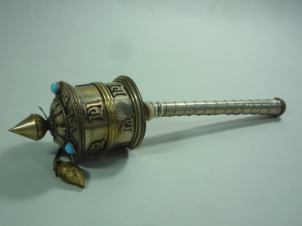 A WHITE METAL BUDDHIST PRAYER WHEEL, with relief characters and turquoise stone mounts,