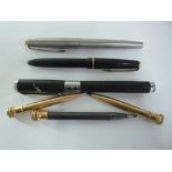 A PARKER SLIMFOLD FOUNTAIN PEN, a Parker 65 SSGT Flighter fountain pen, Mont blanc ballpoint pen,