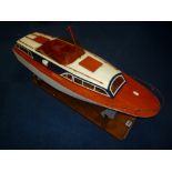 A WOODEN SCRATCHBUILT OR KIT BUILT RADIO CONTROL CABIN CRUISER, not tested, with wooden stand,