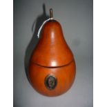 A TREEN PEAR, with hinged lid to inner well, lock and finial metal mounts