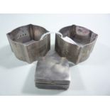 TWO SILVER SHAPED SQUARE NAPKIN RINGS, with engine turned decoration and monograms, together with