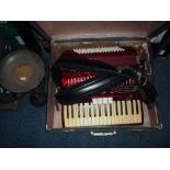 A CASED ACCORDIAN, a cased Everest typewriter and a set of scales (3)