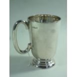 A SILVER MUG, tapering cylindrical form, circular foot, loop handle, Sheffield 1957, Walker &