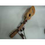 A PERUVIAN CHARANGO 10 STRUNG INSTRUMENT, artisan made from an Armadillo shell and inlaid top