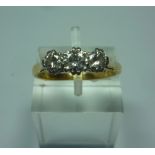 AN 18CT GOLD DIAMOND RING, with three graduated brilliant cut diamonds to the plain tapered shank,