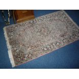 A SMALL PINK GROUND RUG, 'Made in India' label attached, approximate size 153cm x 92cm, together