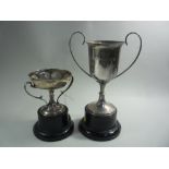 A SMALL SILVER TWO HANDLED TROPHY, on circular plinth, Sheffield 1911, approximately 16cm high,