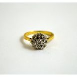 A DIAMOND CLUSTER RING, with central old cut diamonds within a surround of heart shape petals to the