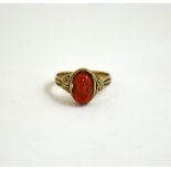 A CORAL CAMEO RING, with oval shape carved relief of a woman to the fancy border and sides,