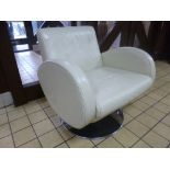 A LEATHER SWIVEL ARMCHAIR, on a chrome stand