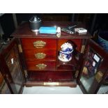 A SMOKER'S CABINET, interior with three drawers, shelves and ceramic tobacco jar/cover, with front